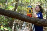 University of Arkansas graduate student Rose Feinstein sets up the laser level for a survey.