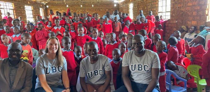 Sara Beck and Paul Onkundi Nyangaresi (center) with students and staff of Rianyabayo Memorial Academy.